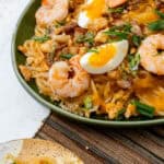 pancit palabok served on a green plate.