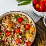 Ensaladang talong (filipino eggplant salad) served on a plate with ingredients peeking at the top and a fork on the bottom right.