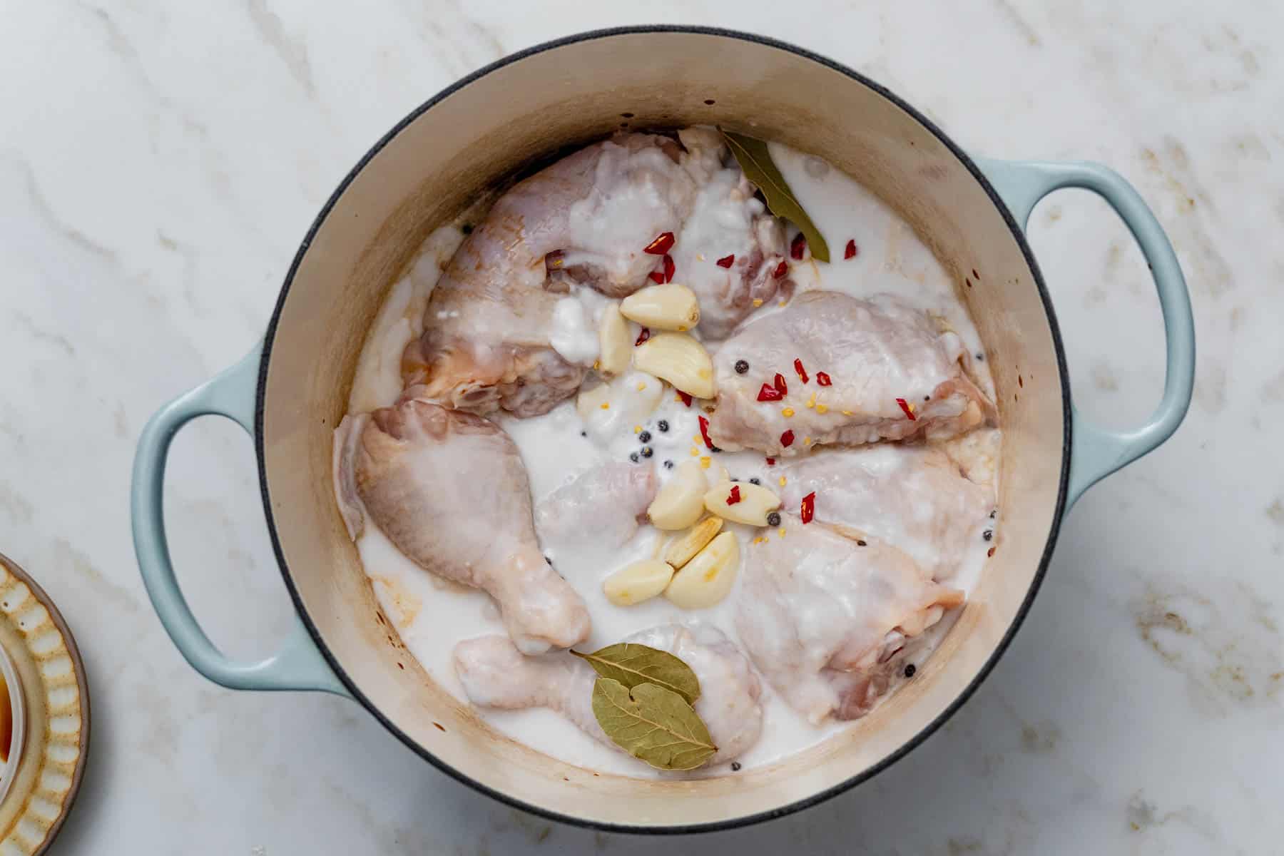 chicken adobo marinating in dutch oven.