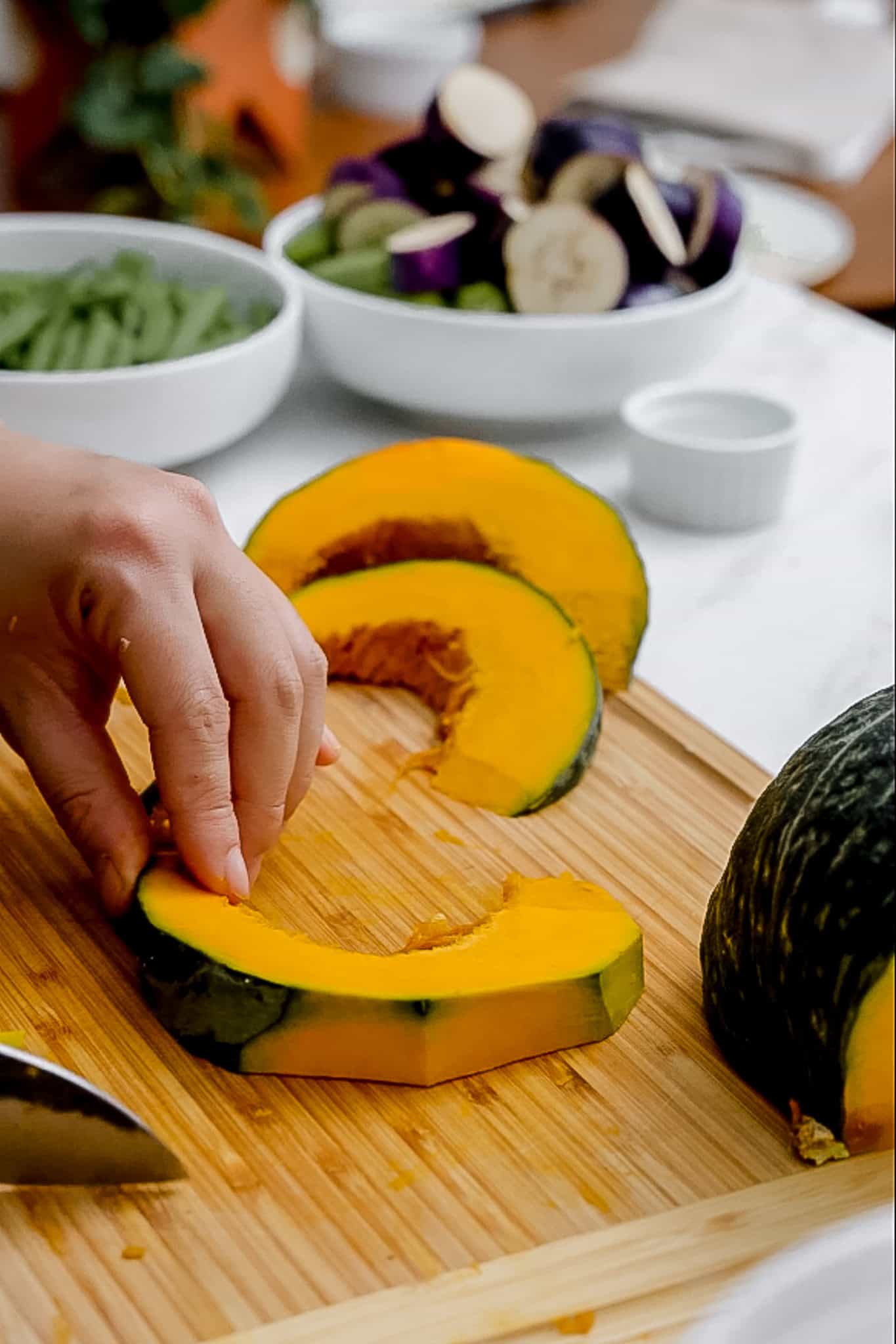 cutting skin off kabocha squash.