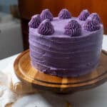 ube cake on display on cake stand.