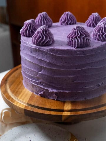 ube cake on display on cake stand.