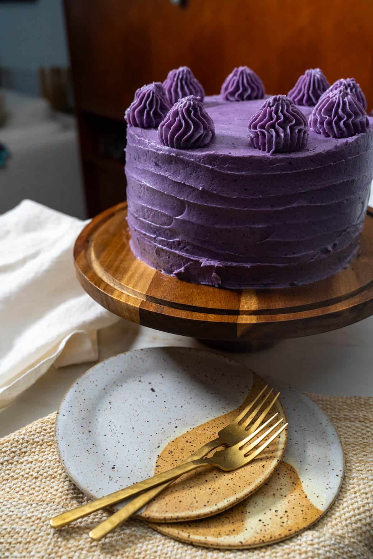 ube cake on cake stand.