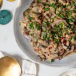 beef lengua with mushroom sauce plated.