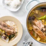 pork sinigang in pot and served in a bowl with rice.