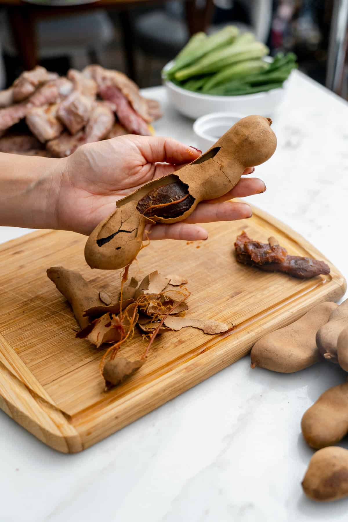 removing shell of tamaring pod.