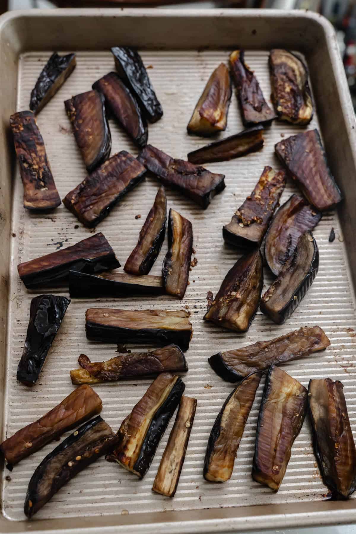 roasted eggplants on baking tray.