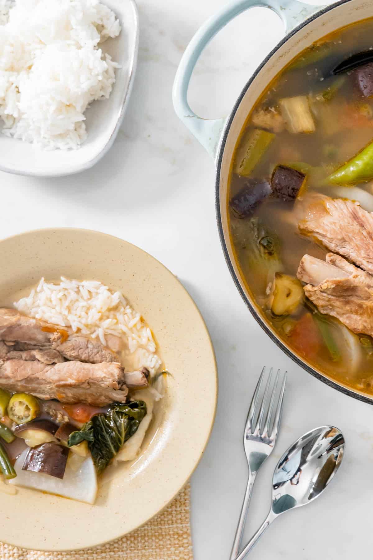 served sinigang in a bowl with rice.